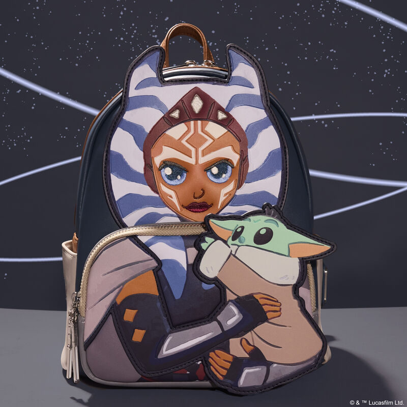 Loungefly The Mandalorian Ahsoka and Grogu mini backpack featuring Ashoka in appliqué detail holding Grogu on the front pocket. The bag sits against a blue background with swooping white stripes.